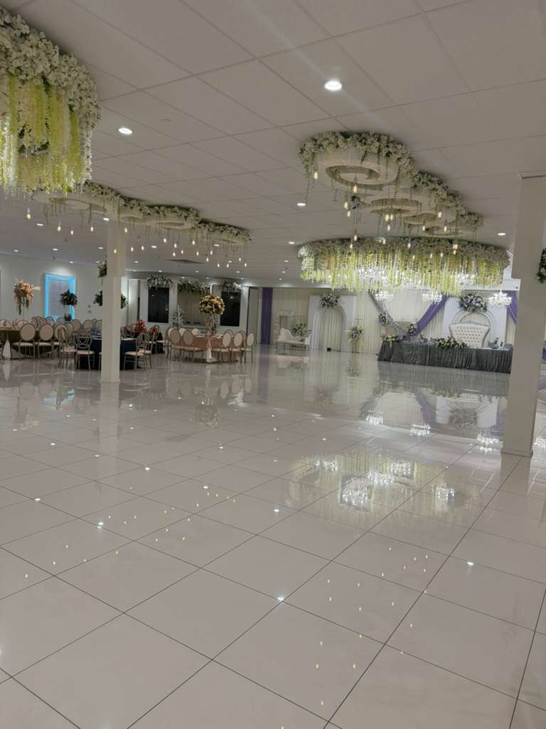 Beautiful wedding reception hall with string lights and elegant table settings
