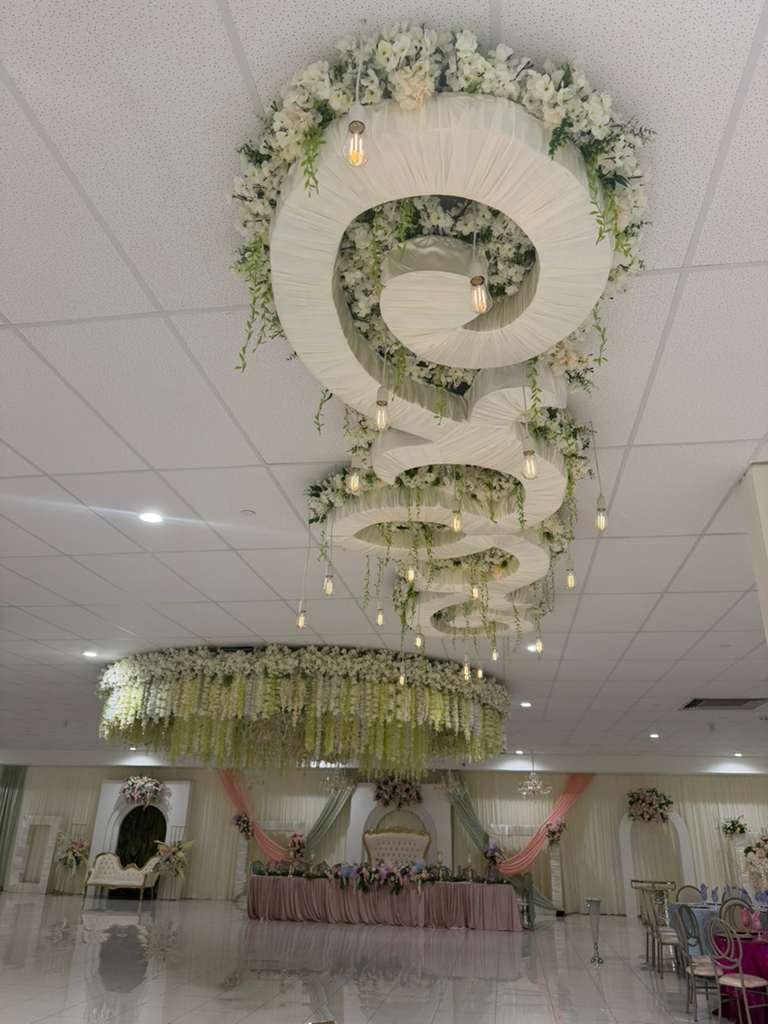 Couple touring an elegantly decorated event venue with a coordinator